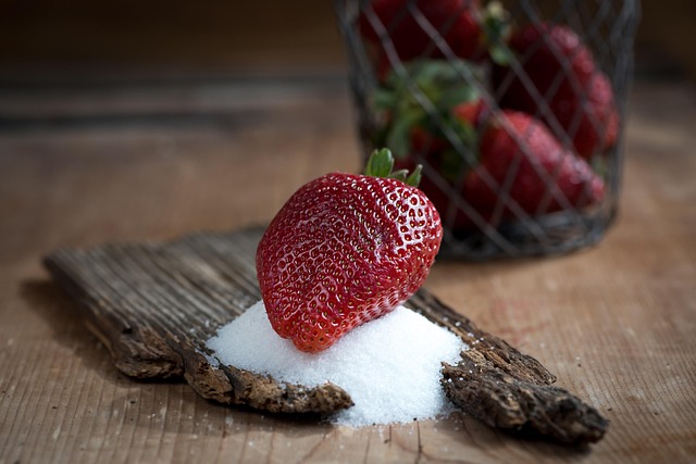 Ripe red strawberries growing in hanging planter on garden patio with green leaves